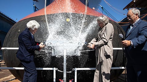 Janet Wilson Taylor, daughter of the late General Louis H. Wilson Jr., and Susan J. Rabern, former US Assistant Secretary of the Navy for Financial Management and Comptroller, smash the ceremonial champagne bottles against the hull of the guided-missile destroyer USS Louis H. Wilson Jr. during her christening ceremony, September 27, 2025.
