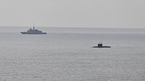 A French Navy frigate observing Russian submarine Novorossiysk after it surfaced off the French coast