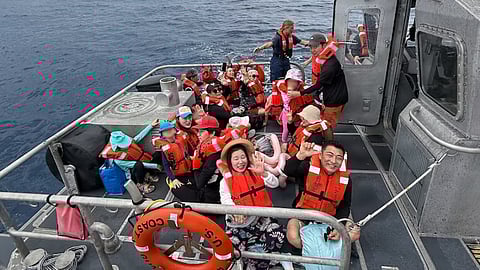 US Coast Guard 45-foot response boat-medium crews from Station Apra Harbor assist passengers aboard Princess Guam, a disabled passenger vessel, off Agat, Guam, October 10, 2025. Coast Guard watchstanders received a notification on VHF-FM channel 16 from the vessel’s crew reporting smoke coming from the engine compartment and that 45 people were aboard.