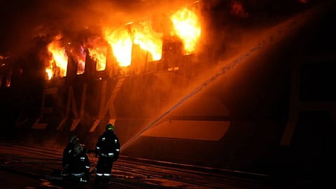 Firefighters responding to a burning vessel after a Russian attack on the Port of Chornomorsk in Ukraine, December 12, 2025 