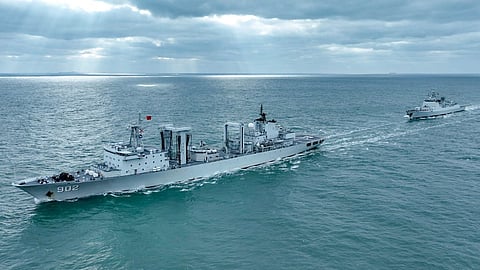 Dong Pinghu (Hull 902) and Type 052D guided-missile destroyer Zhumadian (Hull 127) attached to a naval flotilla under the Chinese PLA Navy sail in formation during a replenishment-at-sea training exercise in mid-December, 2025