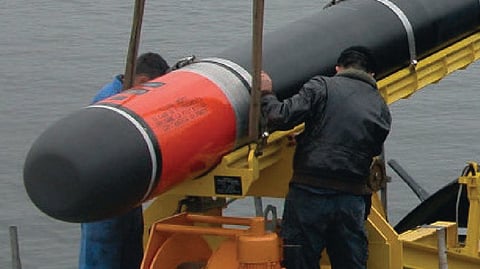Personnel handling a Black Shark heavyweight torpedo
