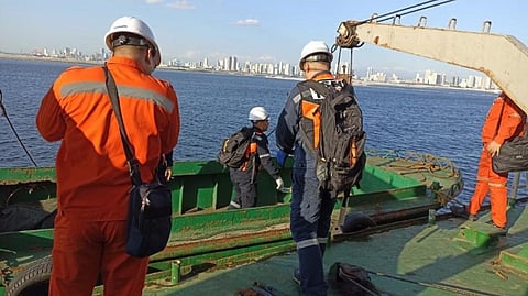 Philippine Coast Guard personnel inspecting a dredger in Manila Bay in late March 2024
