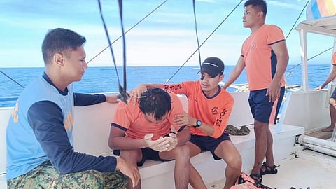 Philippine Coast Guard and Philippine National Police personnel attend to a survivor of the capsizing of the dive tour boat Amejara in Davao Gulf in the southern Philippines, January 20, 2026.
