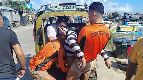 Philippine Coast Guard personnel carry the body of a woman who died after the motor launch on which she was a passenger capsized off Surigao City in the southern Philippines on January 18, 2026.