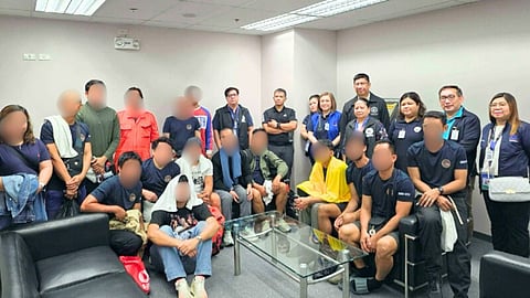 The 15 rescued crewmembers of the ill-fated bulk carrier Devon Bay upon their arrival in Manila, January 26, 2026. The survivors are seen here with officials of the Philippine Department of Migrant Workers.