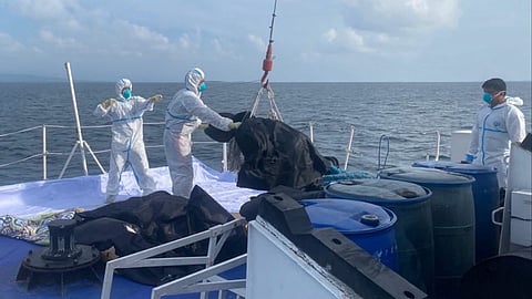 Philippine Coast Guard personnel handle the remains of some of the victims of the sinking of the ferry Trisha Kerstin 3 in the waters off Basilan province in the southern Philippines. The incident, which occurred on January 26, 2026, left at least 40 dead.