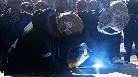 Jane Ginsburg welds her initials onto the keel plate of the ship honouring her mother, former US Supreme Court Justice Ruth Bader Ginsburg, at General Dynamics NASSCO's facilities in San Diego, February 13, 2026. The future USNS Ruth Bader Ginsburg will be the eighth John Lewis-class fleet replenishment oiler to be built for the US Military Sealift Command.