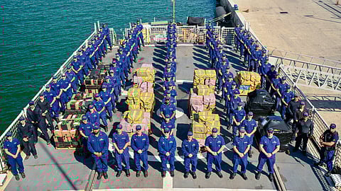 The crew of the US Coast Guard medium endurance cutter USCGC Seneca stand for a photo during a drug offload at Port Everglades in Fort Lauderdale, Florida, February 13, 2026. The crew offloaded more than 17,750 pounds of illicit narcotics worth more than US$133 million as a result of four interdictions in the international waters of the Eastern Pacific Ocean.