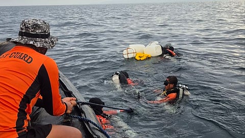Philippine Coast Guard personnel work to recover the remains of one of the more than 65 people who perished after the Ro-Pax ferry Trisha Kerstin 3 sank off Basilan province on January 26, 2026. Among those who were on board the vessel at the time of the incident, 293 survivors have been recorded while 14 are still unaccounted for as of February 24, 2026.