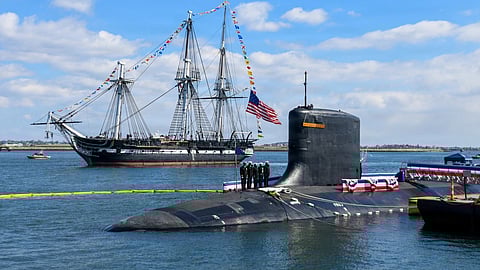 USS Constitution, the oldest commissioned warship still afloat, sails past the Virginia-class nuclear-powered fast-attack submarine USS Massachusetts during the latter's commissioning in Boston, March 28, 2026.