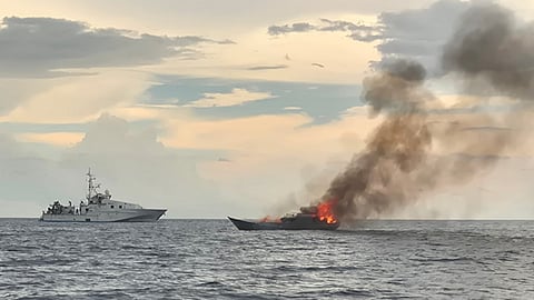 Illegal foreign fishing vessel being burned at sea