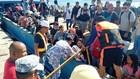 Philippine Coast Guard personnel assist in the disembarkation of the rescued passengers of the grounded ferry Our Lady of Fatima 03 at Tilik Port in Occidental Mindoro province, April 5, 2026. The passengers had been evacuated onto another ferry, which then transported them to shore.