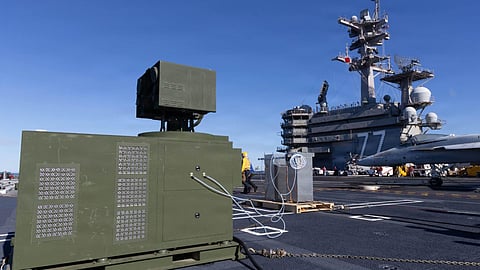 AeroVironment's palletised laser weapon system set up on the flight deck of the US Navy aircraft carrier USS George H. W. Bush. The system was successfully demonstrated on board the carrier in October 2025 when it tracked, engaged, and neutralised multiple target drones.