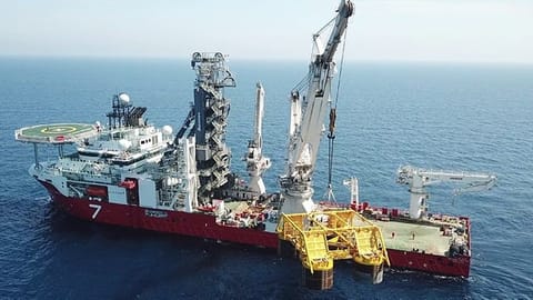 Subsea 7 vessel performing installation work. An extensive array of equipment is seen on the vessel's deck.