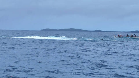 Philippine Coast Guard personnel on a small boat in the area where the cargo vessel LCT Pacifica 3 capsized and broke into two pieces off Surigao del Norte province, April 30, 2026