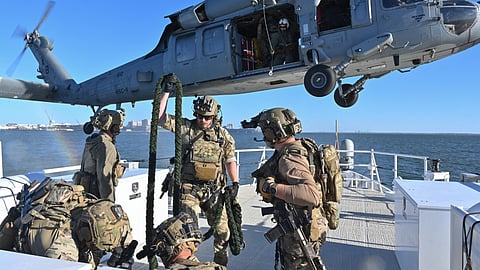 US Coast Guard deployable specialised forces assigned to the Coast Guard Maritime Security Team – East stow a fast rope during training with a US Navy MH-60S Seahawk helicopter aircrew from the Helicopter Sea Combat – Squadron 11 while underway aboard the fast response cutter USCGC Richard Snyder on the James River in Newport News, Virginia, October 22, 2025.