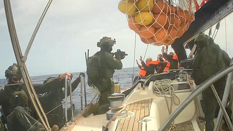 Israeli forces boarding a boat part of an activist flotilla attempting to break a naval blockade on Gaza