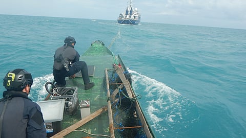 Two Australian Border Force officers secure a foreign vessel suspected of illegal fishing off Croker Island in the Northern Territory, May 18, 2026.