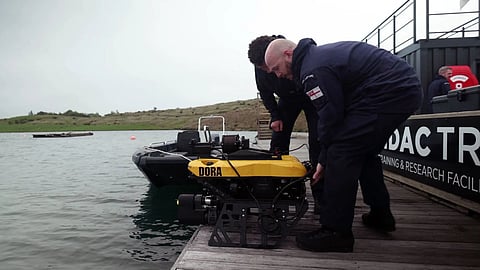 The black and yellow ROV about to be deployed into the water for a practice run