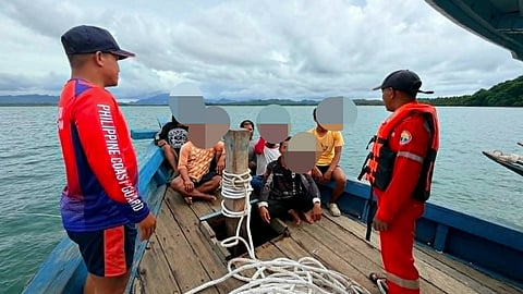 Philippine Coast Guard personnel watch over the rescued crew of the fishing vessel Nornina A off Palawan province. The vessel suffered water ingress while returning to her homeport on June 22, 2026, forcing the crew to abandon her.
