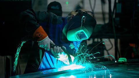 Chief Warrant Officer Beth Slade, commanding officer National Motor Life Boat School, welds her initials onto the keel of the US Coast Guard's first special purpose craft – heavy weather II during a keel laying authentication, in Mount Vernon, Washington, July 8, 2026.