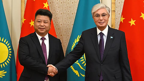 Yu Boyan, Chairman of the board of the Guoyou Materials Industry Group, shakes hands with Kassym-Jomart Tokayev, President of Kazakhstan.
