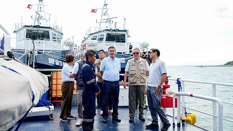 Philippine President Ferdinand Marcos Jr. (far fight) speaks with the crew of a Philippine Bureau of Fisheries and Aquatic Resources patrol vessel during a visit to the modernised Sual Fish Port Complex in Pangasinan Province, July 30, 2026.