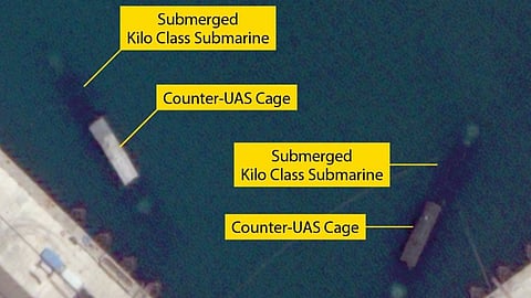 Satellite photograph of what appear to be two Russian Navy Kilo-class submarines fitted with counter-UAS cages at the Port of Novorossiysk, June 13, 2026