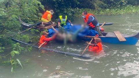 Philippine Coast Guard personnel recover the body of one of nine people who perished after a boat capsized while transiting Mapanuepe Lake in Zambales province three days prior, August 30, 2026.