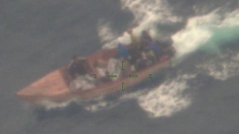 A makeshift vessel carrying 19 aliens onboard just before being interdicted by the US Coast Guard fast response cutter USCGC Richard Dixon in Mona Passage waters off Puerto Rico, August 24. 2026.