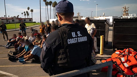 US Coast Guard personnel stand guard over the 37 interdicted aliens before they are handed over to the US Border Patrol.