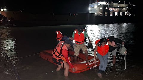 Philippine Coast Guard personnel use a liferaft to evacuate some of the passengers from the grounded ferry Roromaster 5 off Occidental Mindoro province, September 17, 2026. The ferry ran aground 30 metres from shore while nearing Occidental Mindoro's Port of Abra de Ilog.