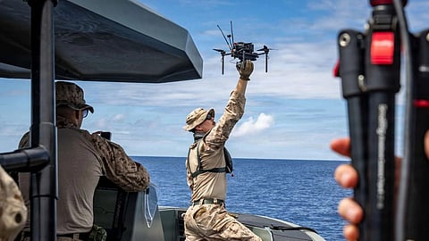 US marine launches a Neros Archer drone from a reconnaissance craft at sea off Okinawa