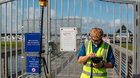 Derek Thorn, a geographer with the US Army Corps of Engineers, Charleston District, conducts topographic surveys near Brittlebank Park and the Ashley River bridges on the westside of downtown Charleston, South Carolina, September 11, 2026. The surveys will determine precision elevation markers for a planned perimeter storm surge barrier.