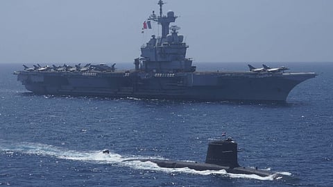 An Indian Navy Kalvari-class submarine sails alongside the French Navy aircraft carrier Charles de Gaulle during Varuna 2021, a series of bilateral exercises in the Indian Ocean held from April 25 to 27, 2021.
