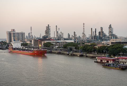 Photo of vessel docked next to refinery along Huangpu River, China