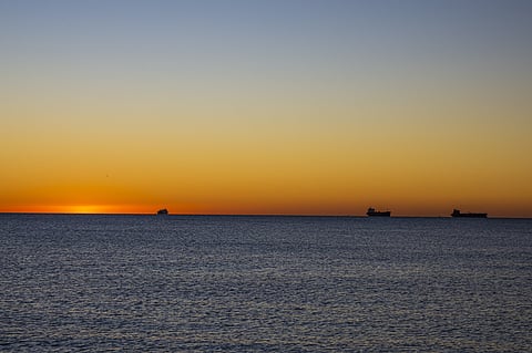 Photo of vessels passing Gibraltar at sunrise