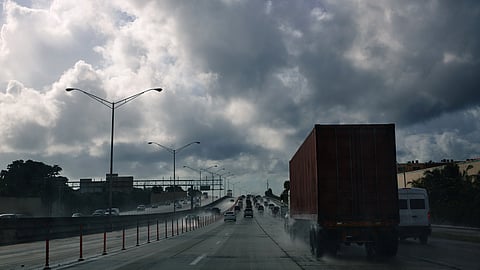 Photo showing trucks on main road on rainy day in Miami