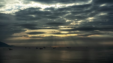 Photo of vessels near coast of South Korea, with sun rays beaming through clouds