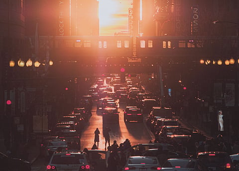 Photo of silhouette of people and cars during sunset in Chicago