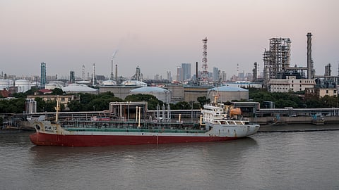Photo of vessel in front of a refinery and storage tanks in China