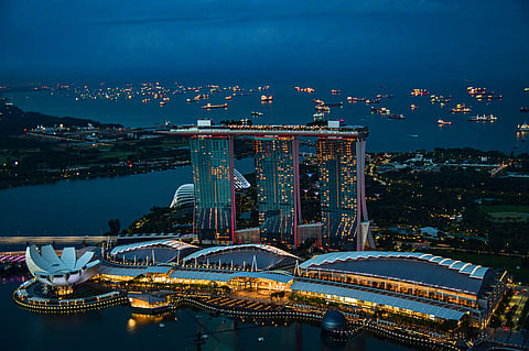 Photo of night view of Marina Bay Sands, Singapore with illuminated skyline and waterfront
