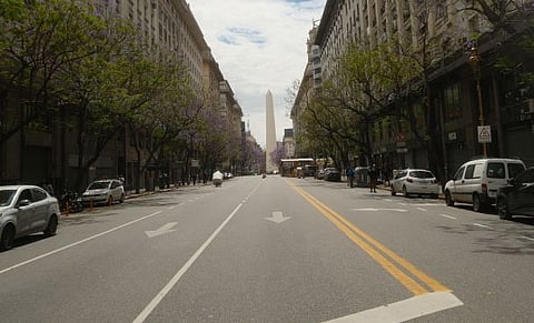 Photo of Buenos Aires avenue with historic obelisk under a clear sky