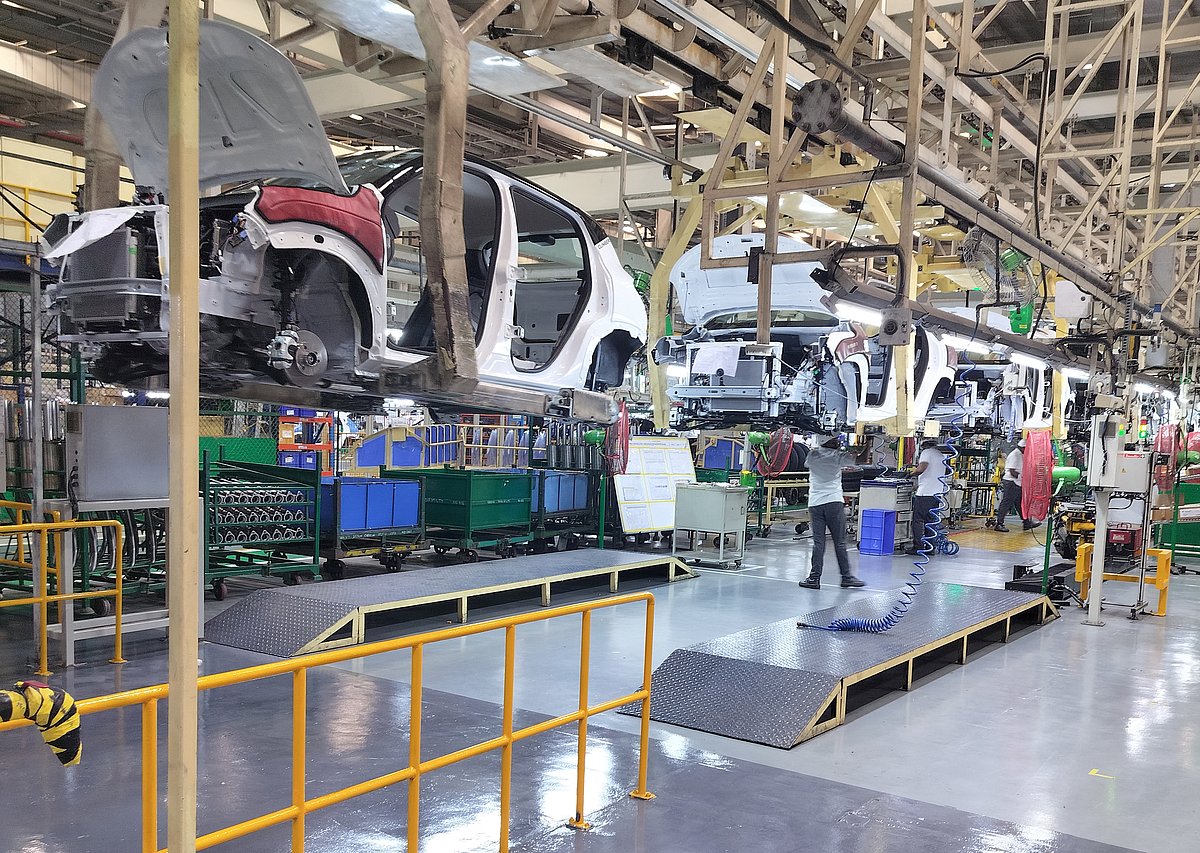 Employees assemble different parts onto car panels at an assembly line inside the manufacturing plant of Renault Nissan Automotive India in Oragadam in the southern state of Tamil Nadu, India, March 27, 2024. 