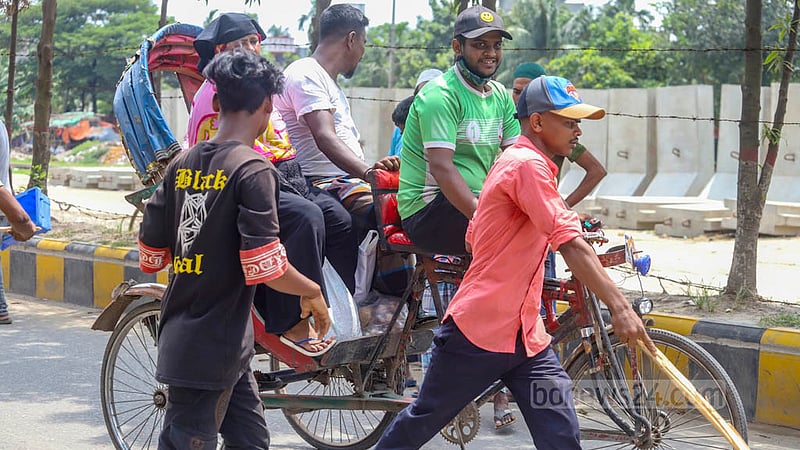 Locals bar battery-run rickshaws in Dhaka's Jurain on Friday, Aug 26, 2022, two days after a rickshaw hit and killed a school student in the area.