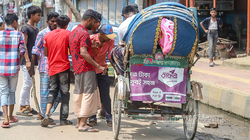 Locals bar battery-run rickshaws in Dhaka's Jurain on Friday, Aug 26, 2022, two days after a rickshaw hit and killed a school student in the area.