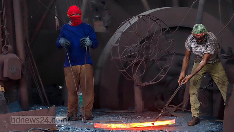 Workers wrap their hands and faces in cloth to protect themselves from the heat of the furnace at the Al-Amin Re-Rolling Mill in Dhaka’s Postagola. Photo: Mahmud Zaman Ovi