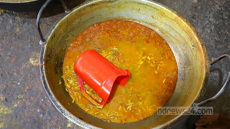 A plastic mug swims in a dish being served at the Haji Muhammad Mohsin Hall canteen at Dhaka University.