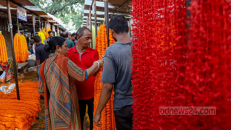 Customers browse flowers at a shop in the Shahbagh flower market on Friday, Sept 2, 2022.